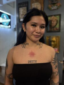 A vibrant red heart tattoo inked on the chest area of an individual.