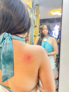 Delicate red heart tattoo, conveying a message of love or passion.