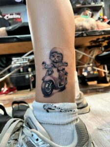 A cat confidently drives a motorcycle, donning a helmet, embodying a whimsical sense of adventure.