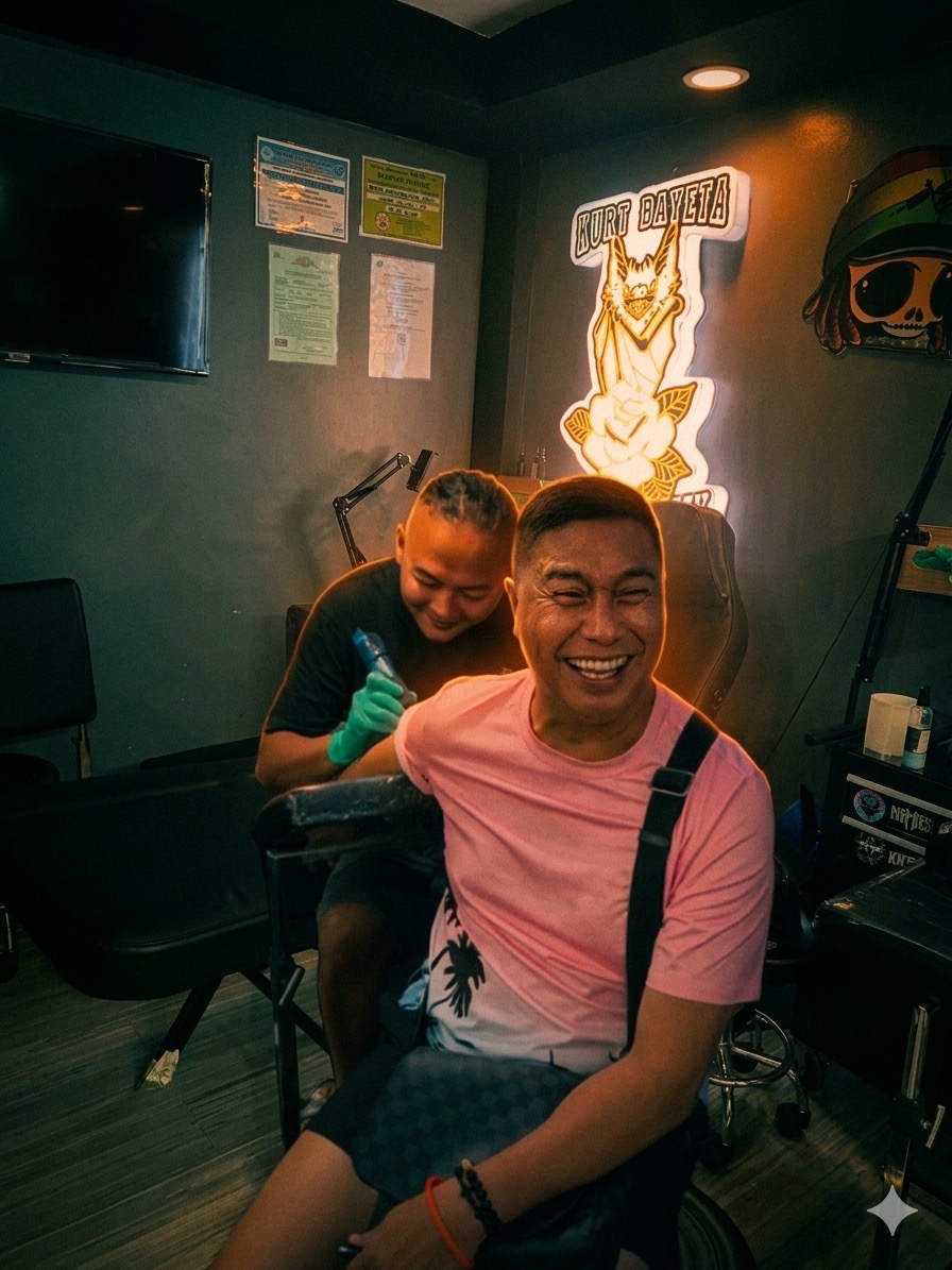 Kurt Bayata applies a tattoo on Jose Manalo in a lively tattoo studio.